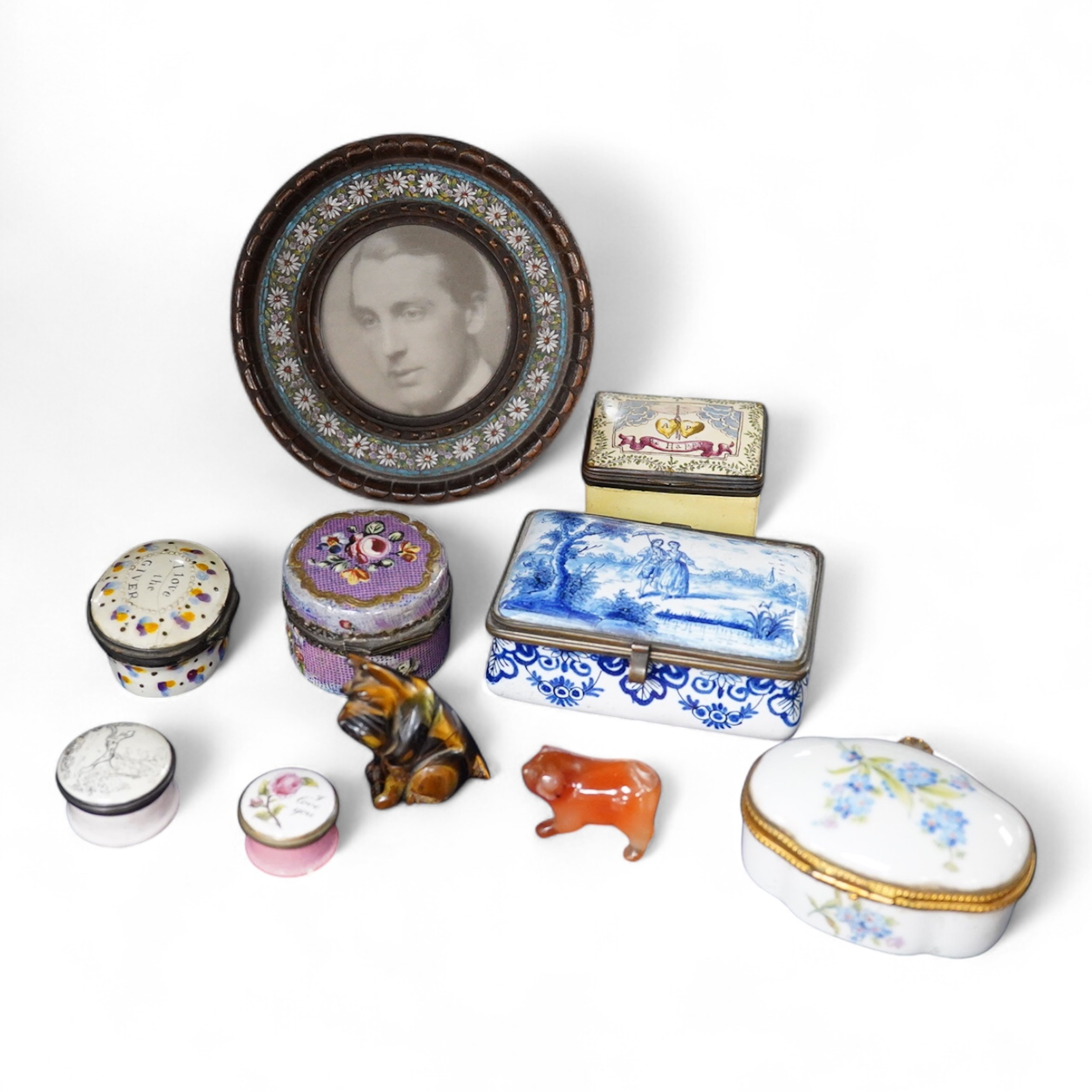 A collection of various 18th century and later trinket/pill boxes, a micro mosaic frame and two small carvings to include a tiger’s eye Scottie dog, frame 10cm in diameter